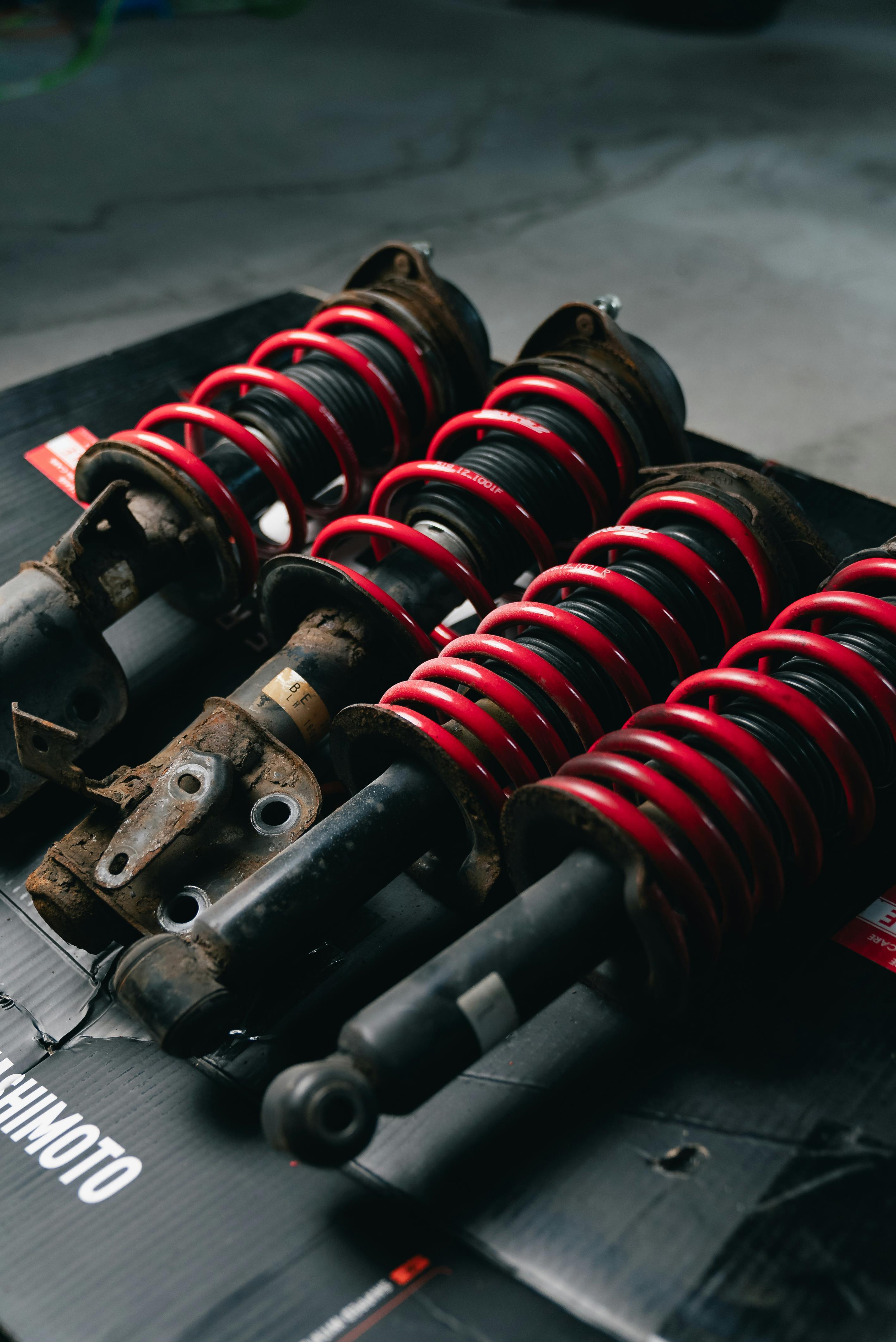 Close-up of Red Coilover Suspensions in Garage